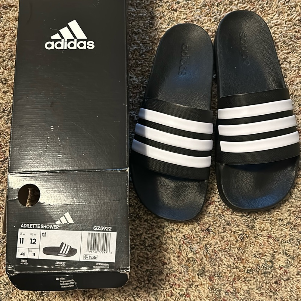 adidas Black and White Adilette Shower Sandals. Men size 11. Women size 12.
